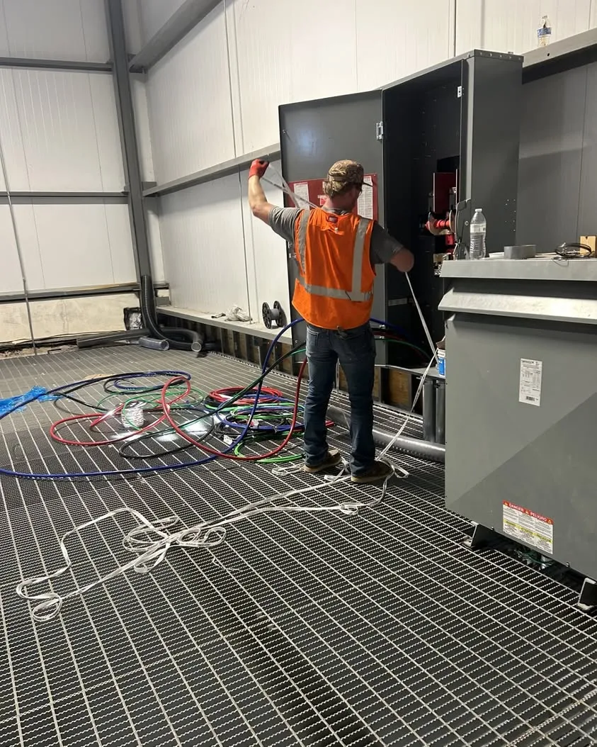 Pulling wire for new machines at a PVC manufacturing plant in Dallas